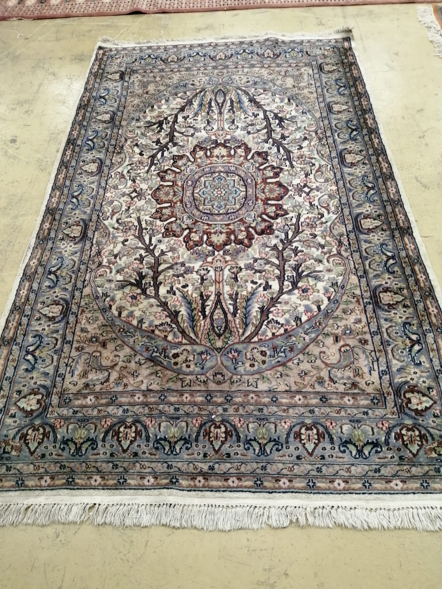 A North West Persian ivory ground rug, 220 x 136cm